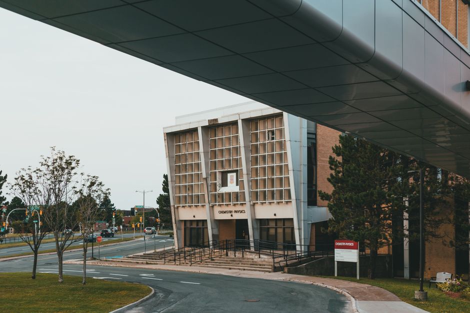 Modern architecture of a university chemistry and physics building captured from an outdoor walkway.