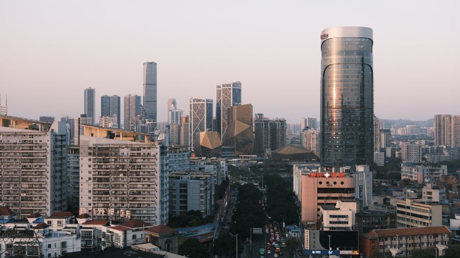 Urban skyline of Liuzhou, Guangxi, China at dusk featuring modern skyscrapers and city buildings.