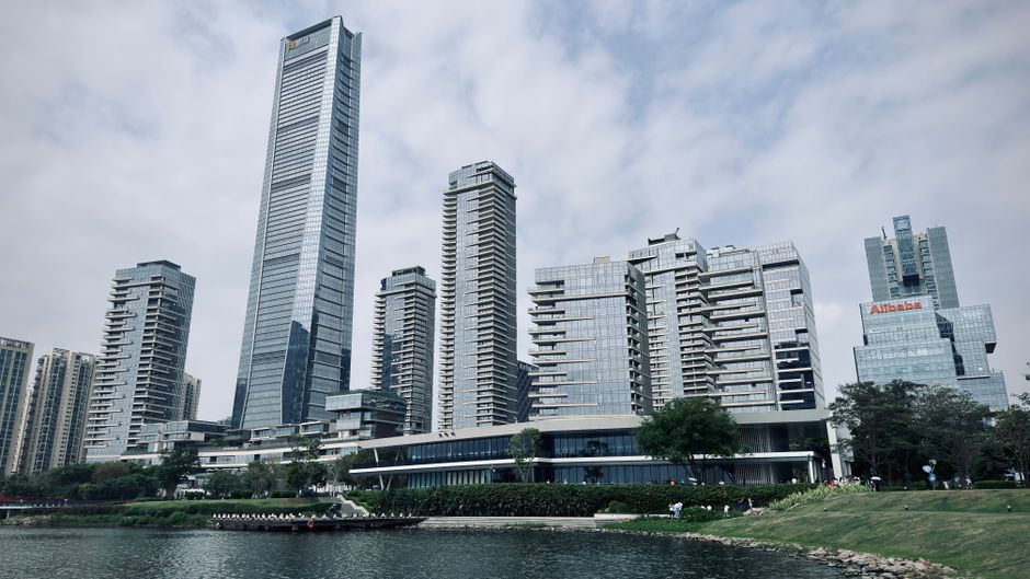 Modern skyscrapers of Shenzhen skyline by the waterfront on a cloudy day.
